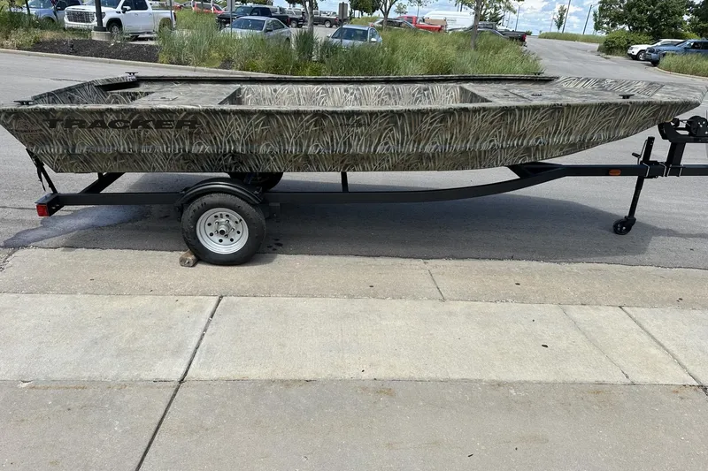 Slide: The Image of 2026 Tracker Grizzly 1648 Utility boat on trailer, parked outdoors. - 5