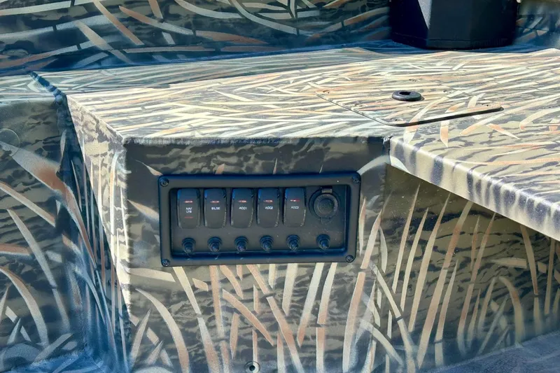 Slide: The Image of 2026 Tracker Grizzly 1650 T Prairie Wings Edition boat with camo design and control panel. - 10