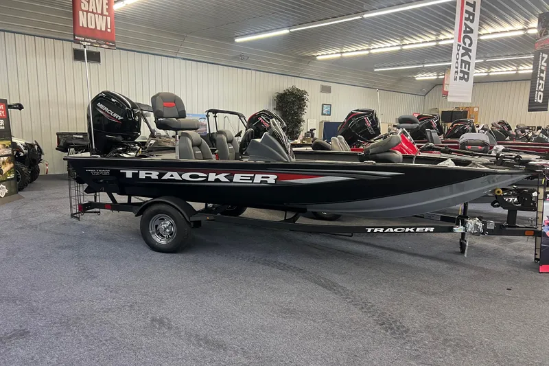 The Image of 2026 Tracker Pro Team 175 boat displayed in showroom with Mercury engine. - 0