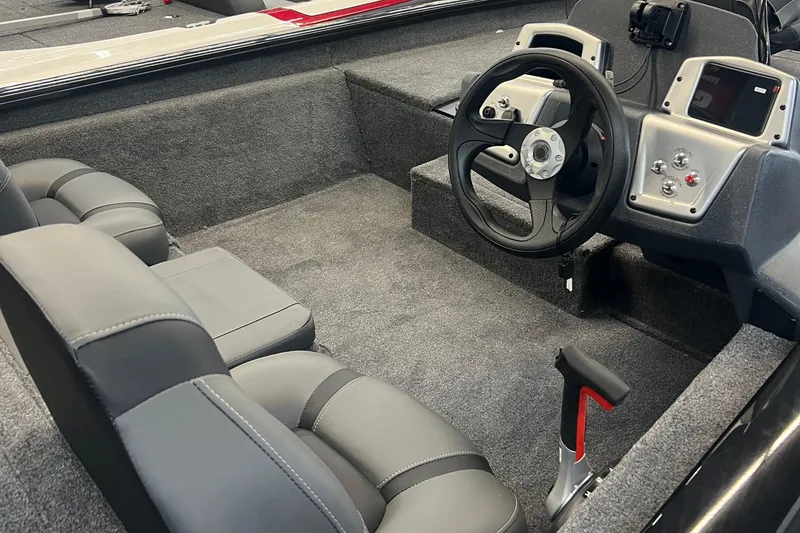 Slide: The Image of 2026 Tracker Pro Team 175 boat interior with steering wheel and dual seats. - 4