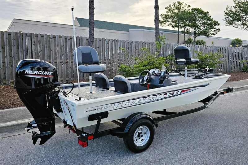 The Image of 2026 Tracker Pro 170 boat with Mercury engine on trailer, parked outdoors. - 0