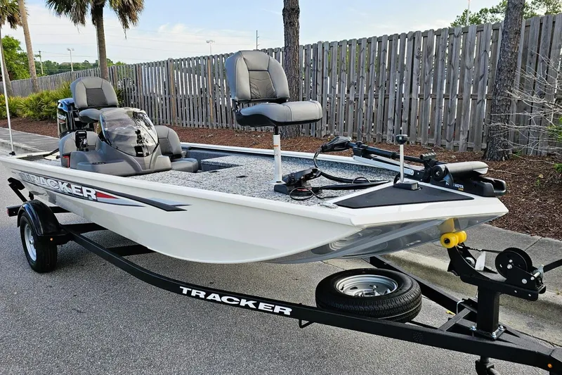 Slide: The Image of 2026 Tracker Pro 170 boat on trailer, parked outdoors, featuring modern seating and equipment. - 4