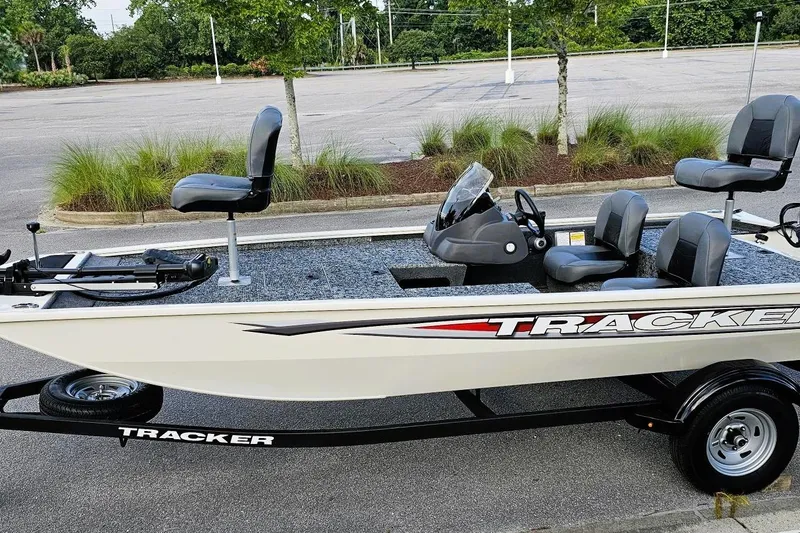 Slide: The Image of 2026 Tracker Pro 170 fishing boat in parking lot, featuring seating and steering console. - 8