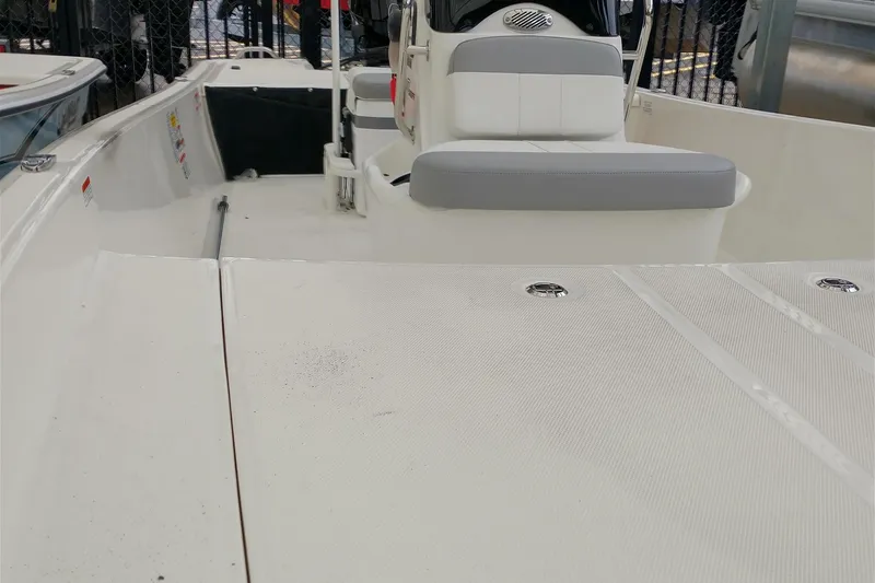 Slide: The Image of 2026 Mako Pro Skiff 17 CC boat interior with seating and console. - 3