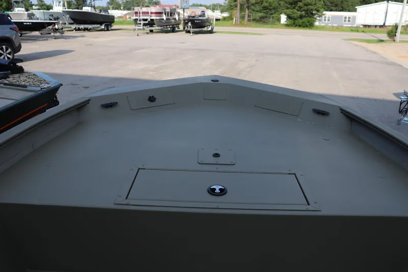 Slide: The Image of 2026 Tracker Grizzly 1860 CC boat deck in a parking lot setting. - 2