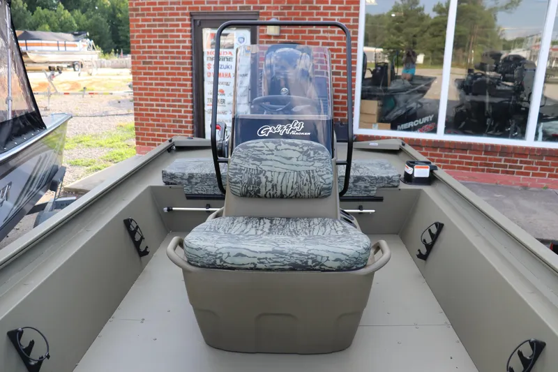 Slide: The Image of 2026 Tracker Grizzly 1860 CC boat interior with camouflage seating and steering console. - 3
