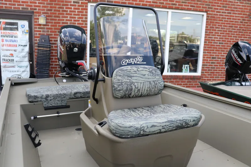 Slide: The Image of 2026 Tracker Grizzly 1860 CC boat with camouflage seating and Mercury outboard motor. - 5