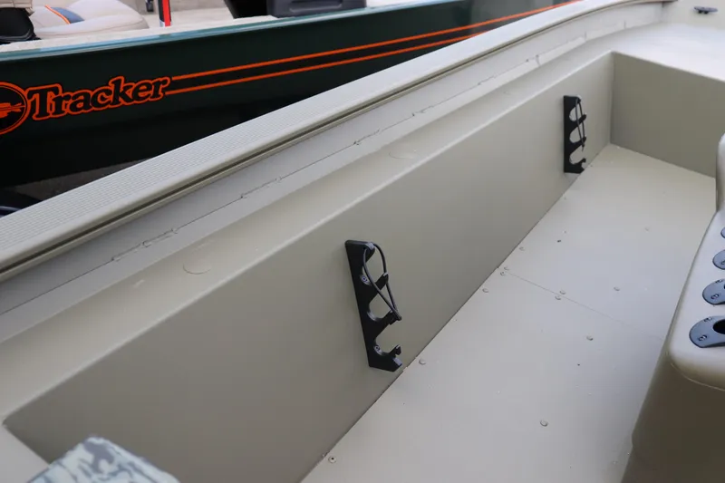 Slide: The Image of 2026 Tracker Grizzly 1860 CC boat interior with rod holders and seating area. - 6
