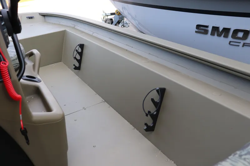 Slide: The Image of 2026 Tracker Grizzly 1860 CC boat interior with rod holders and storage compartments. - 7