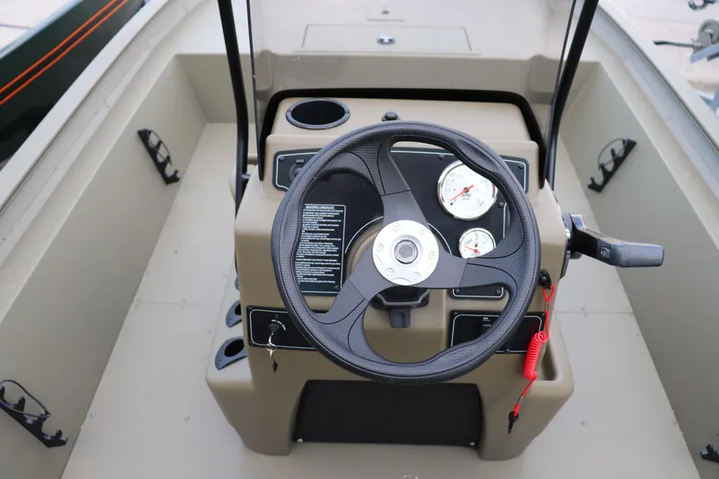 Slide: The Image of Steering console of 2026 Tracker Grizzly 1860 CC boat with gauges and controls. - 8