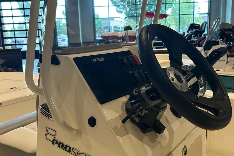 Slide: The Image of 2026 Mako Pro Skiff 17 CC with Mercury outboard motor at Tracker Boats dealership. - 2