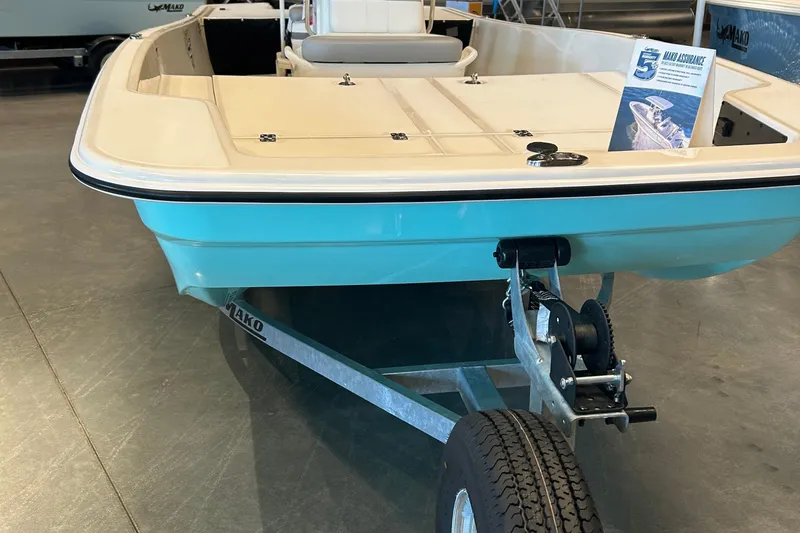 Slide: The Image of 2026 Mako Pro Skiff 17 CC boat displayed outside Bass Pro Shops. - 3