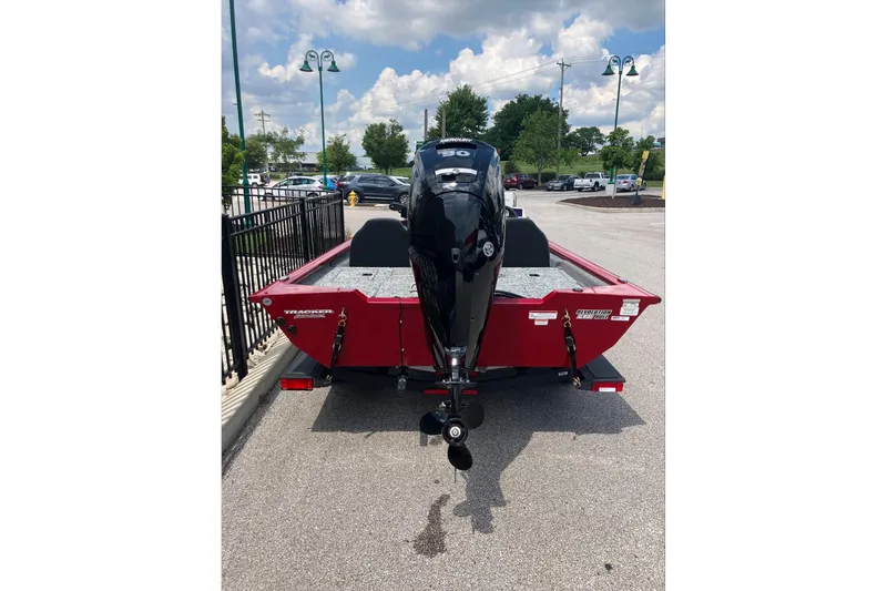 Slide: The Image of 2026 Tracker Pro Team 190 boat with outboard motor, parked outdoors under a cloudy sky. - 3