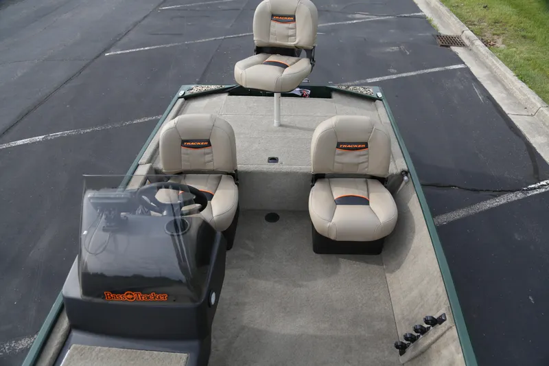 Slide: The Image of 2026 Tracker Bass Tracker Classic Limited boat interior with beige seats and steering console. - 3