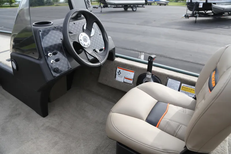Slide: The Image of 2026 Tracker Bass Tracker Classic Limited boat interior with steering wheel and seat. - 4