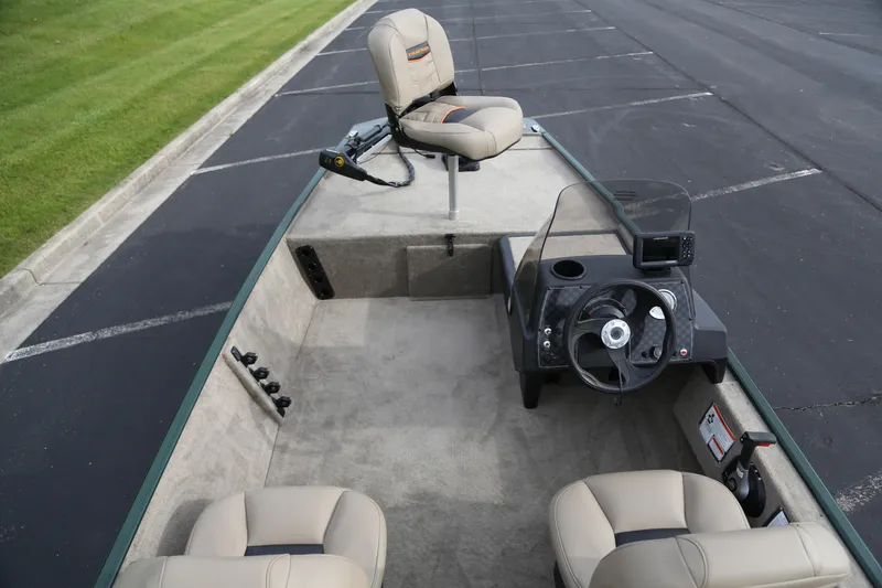 Slide: The Image of 2026 Tracker Bass Tracker Classic Limited boat interior with steering console and seating. - 5