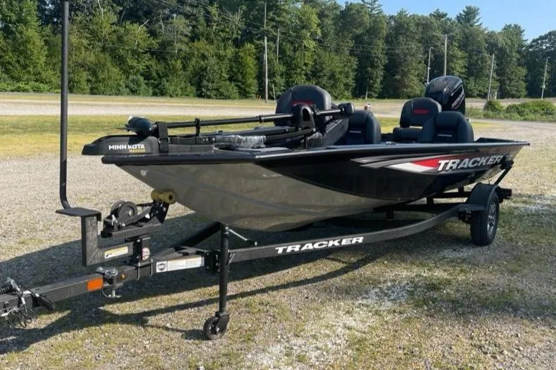 Slide: The Image of 2026 Tracker Pro Team 175 boat on trailer, parked outdoors, with forest background. - 2