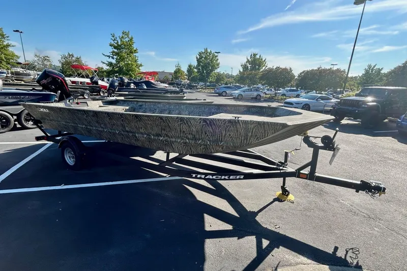 Slide: The Image of 2026 Tracker Grizzly 2072 Utility boat on trailer in parking lot, sunny day. - 2