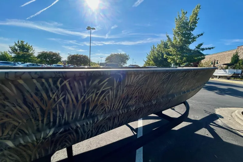 Slide: The Image of 2026 Tracker Grizzly 2072 Utility boat with camouflage design under bright sunlight. - 3