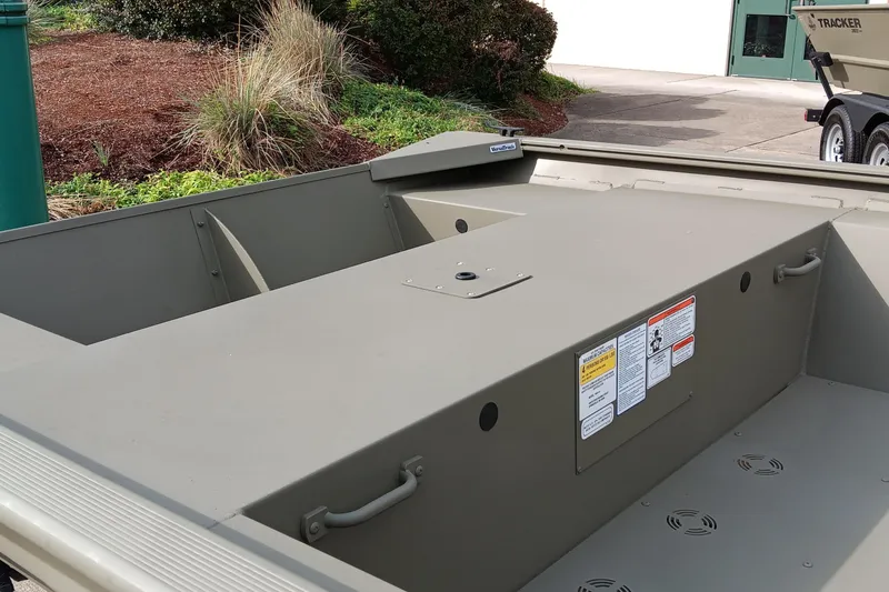 Slide: The Image of 2026 Tracker Grizzly 1754 Utility boat interior with storage compartment and safety labels. - 4