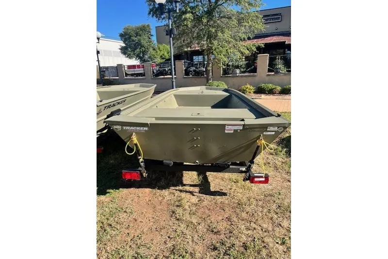 Slide: The Image of 2026 Tracker Grizzly 1648 Utility boat in outdoor setting, rear view. - 19