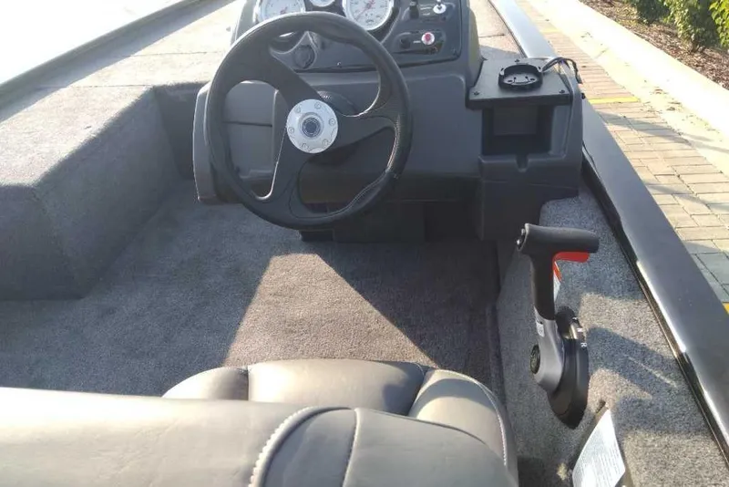 Slide: The Image of Interior of a 2026 Tracker Pro 170 boat, featuring steering wheel and control panel. - 6