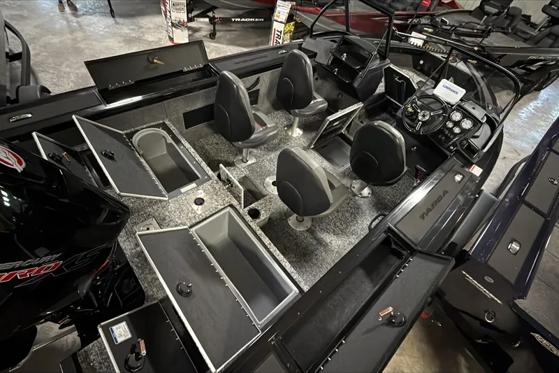 Slide: The Image of 2026 Tracker Targa V-18 WT boat interior with seating, storage compartments, and control panel. - 4