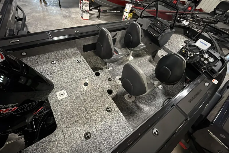 Slide: The Image of 2026 Tracker Targa V-18 WT boat interior with seating and dashboard view. - 6