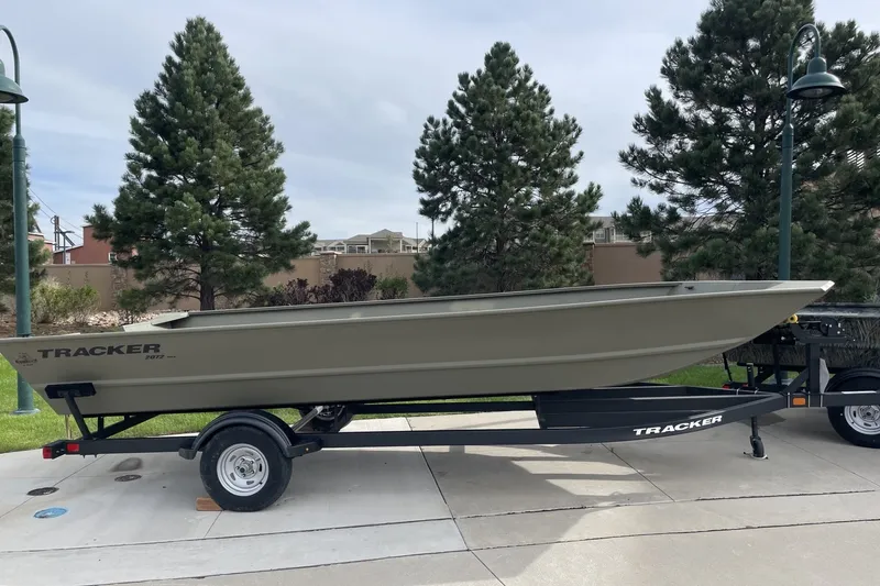 The Image of 2026 Tracker Grizzly 2072 Utility boat on trailer, parked outdoors. - 0