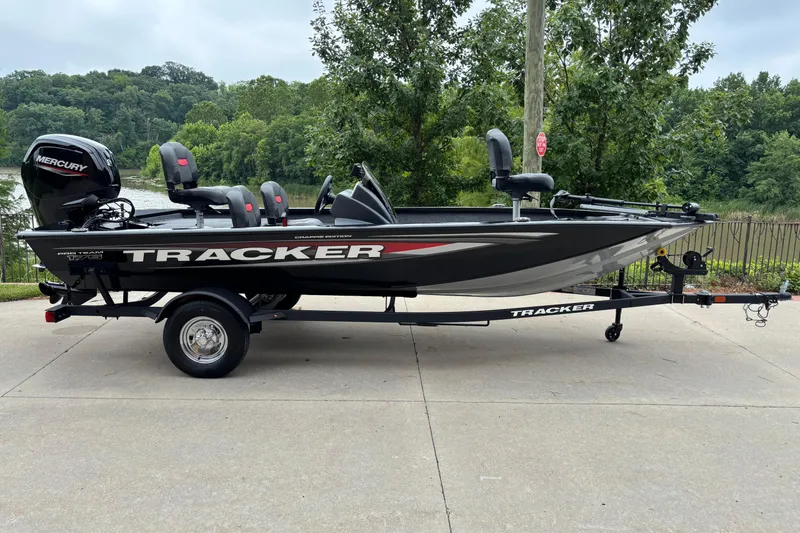 The Image of 2026 Tracker Pro Team 175 Crappie Edition boat on trailer, parked near a scenic lake. - 0