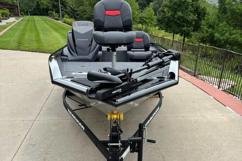 Slide: The Image of 2026 Tracker Pro Team 175 Crappie Edition boat on driveway, featuring sleek design and modern equipment. - 2