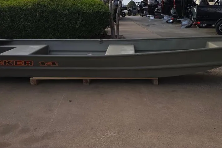The Image of 2026 Tracker Grizzly 14 Jon boat displayed outdoors on wooden supports. - 0