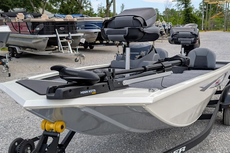 Slide: The Image of 2026 Tracker Pro 170 boat with Minn Kota trolling motor in a marina setting. - 2