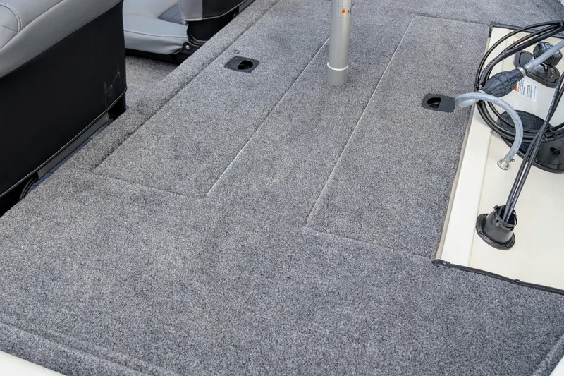 Slide: The Image of 2026 Tracker Pro 170 boat interior with gray carpeted deck and seating. - 4