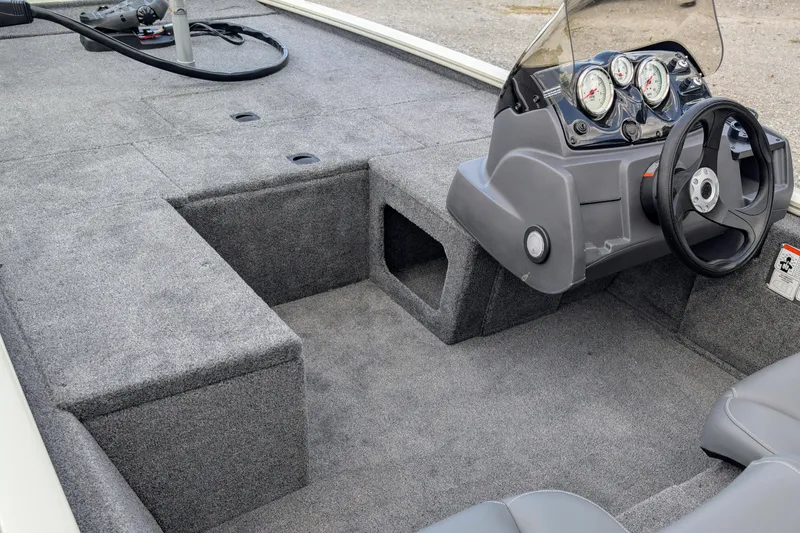 Slide: The Image of 2026 Tracker Pro 170 boat interior with steering console and carpeted flooring. - 5
