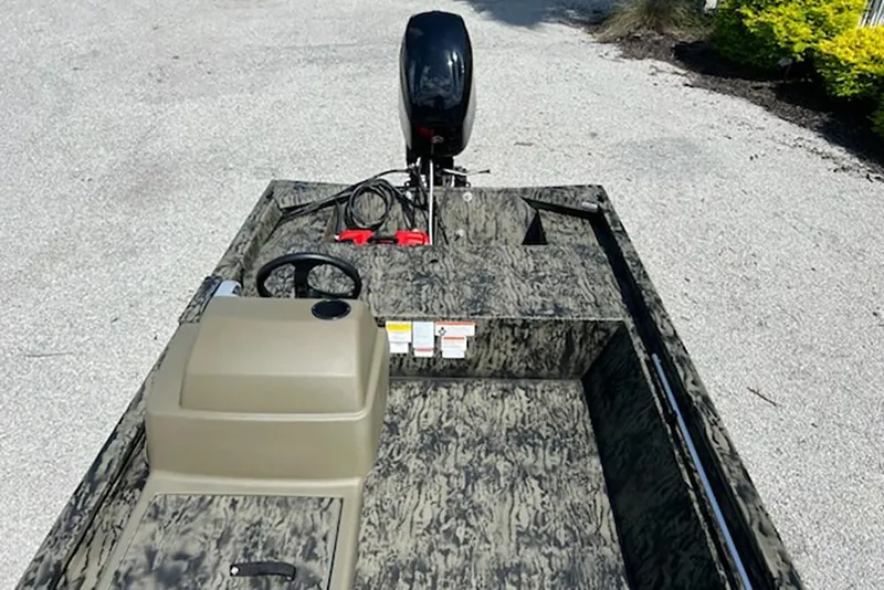 Slide: The Image of 2026 Tracker Grizzly 1648 SC boat with camouflage design and steering console. - 10