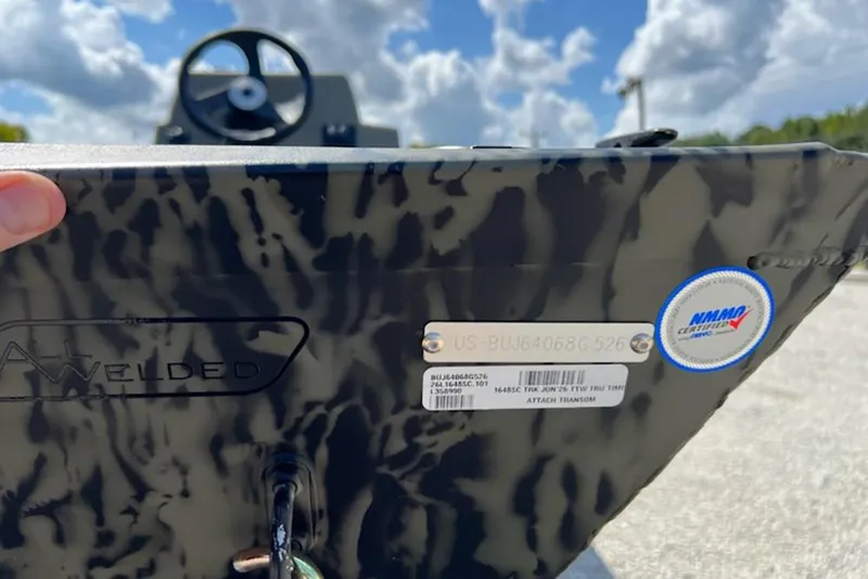 Slide: The Image of 2026 Tracker Grizzly 1648 SC boat with all-welded design and certification label. - 12