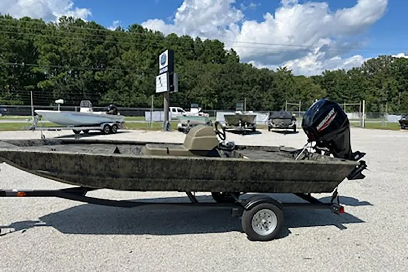Slide: The Image of 2026 Tracker Grizzly 1648 SC boat on trailer in outdoor dealership lot. - 3