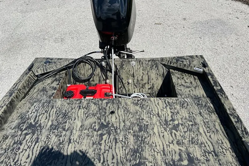 Slide: The Image of 2026 Tracker Grizzly 1648 SC boat with camouflage pattern and outboard motor. - 5