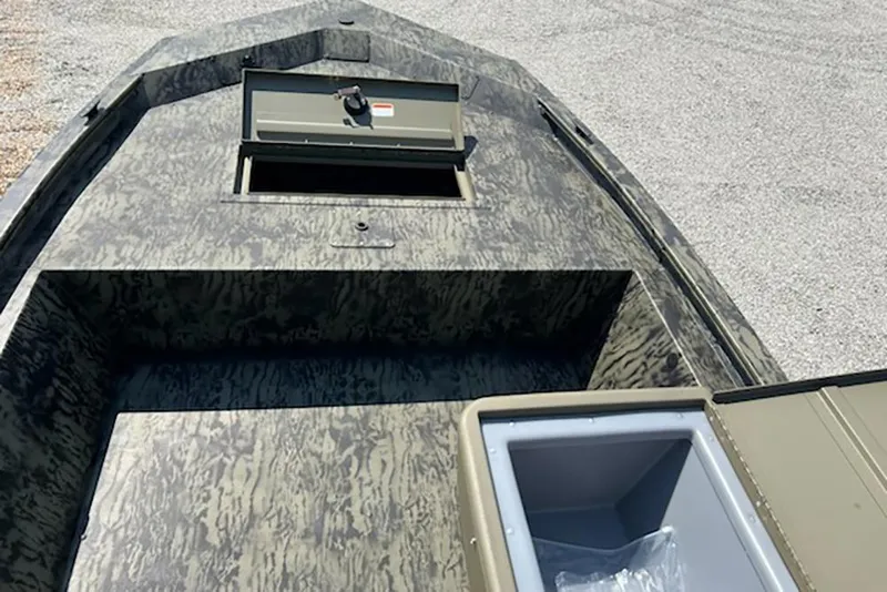 Slide: The Image of 2026 Tracker Grizzly 1648 SC boat interior with storage compartments, camo design. - 9