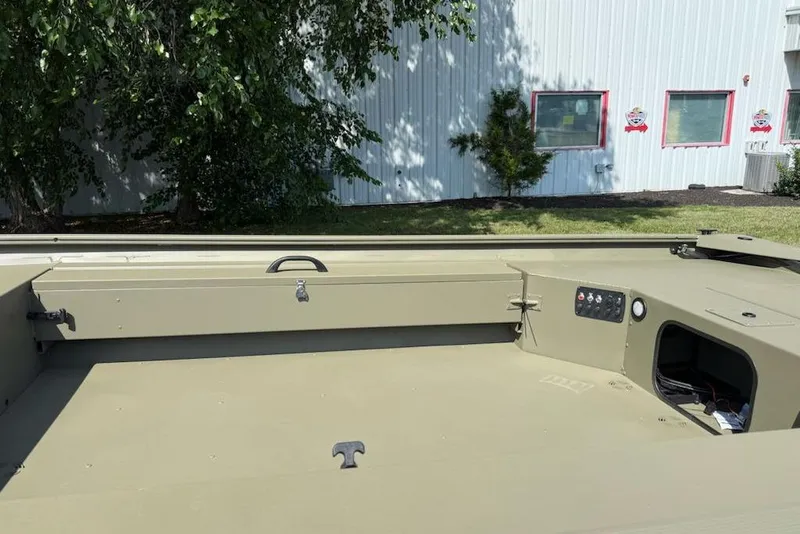 Slide: The Image of 2026 Tracker Grizzly 1654 T Sportsman boat interior, featuring storage and control panel. - 4