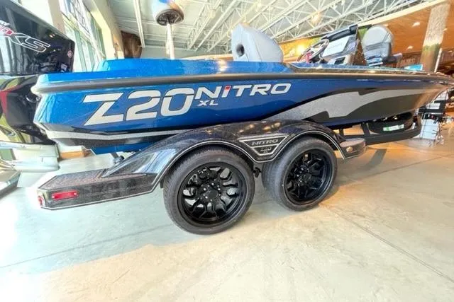 The Image of 2026 Nitro Z20 XL Pro boat with sleek design and dual-axle trailer in showroom. - 0