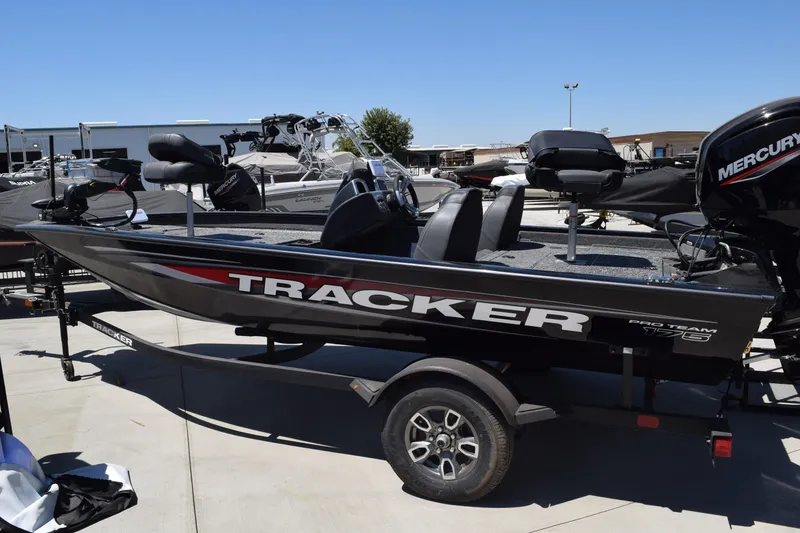 The Image of 2026 Tracker Pro Team 175 boat on trailer, featuring Mercury engine, parked outdoors. - 0