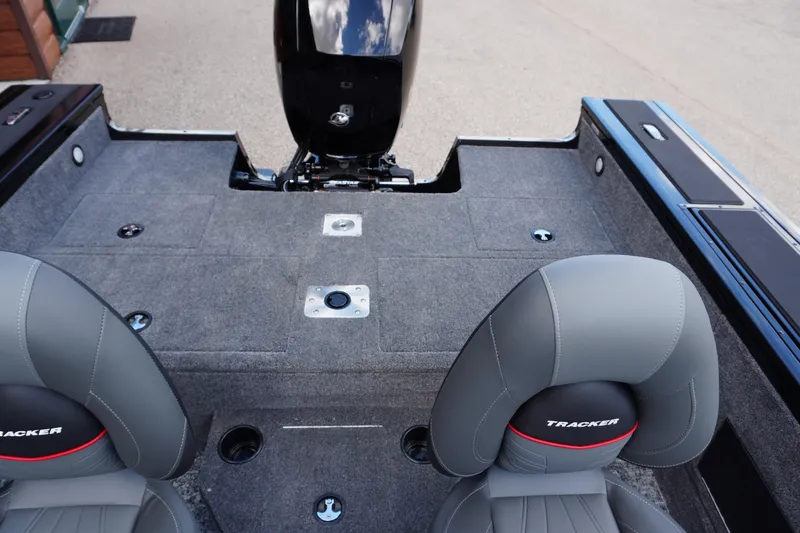 Slide: The Image of 2026 Tracker Targa V-18 WT boat interior with gray seating and carpeted deck. - 17