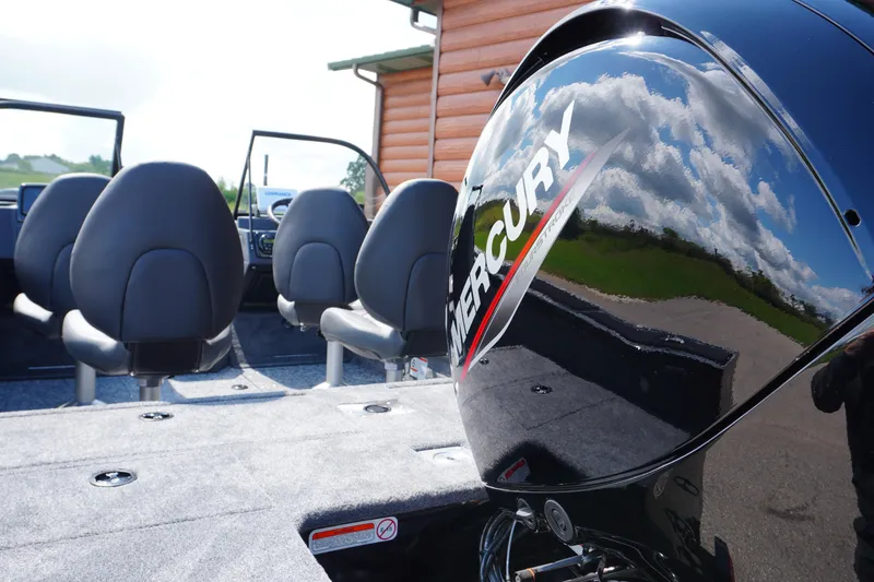 Slide: The Image of 2026 Tracker Targa V-18 WT boat interior with Mercury engine, featuring comfortable seating. - 2