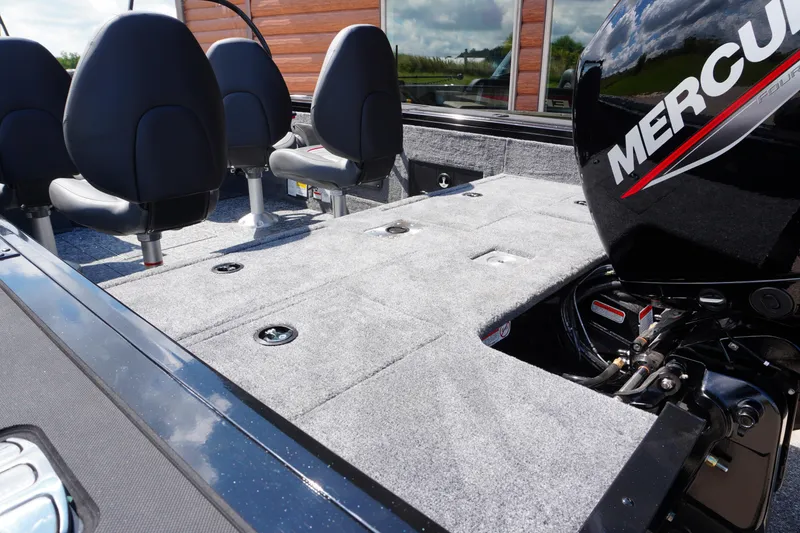 Slide: The Image of 2026 Tracker Targa V-18 WT boat interior with Mercury engine, featuring seating and storage. - 23