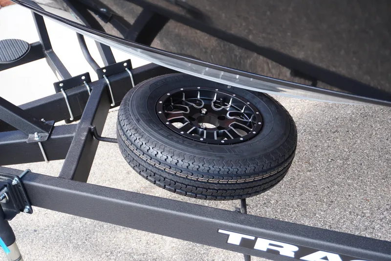 Slide: The Image of 2026 Tracker Targa V-18 WT trailer with spare tire mounted underneath. - 28