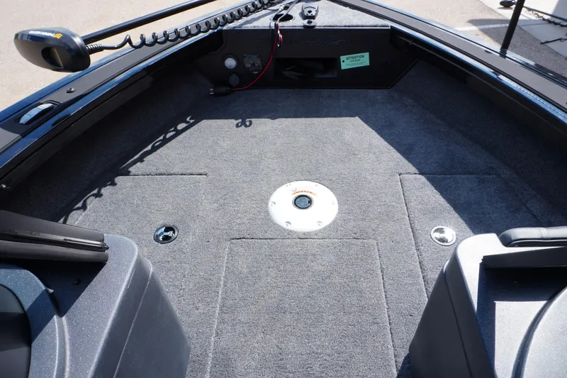 Slide: The Image of 2026 Tracker Targa V-18 WT boat interior with carpeted deck and seating area. - 5