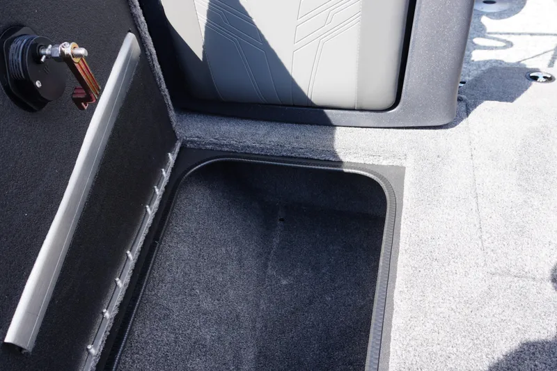 Slide: The Image of 2026 Tracker Targa V-18 WT boat storage compartment with carpeted interior. - 7