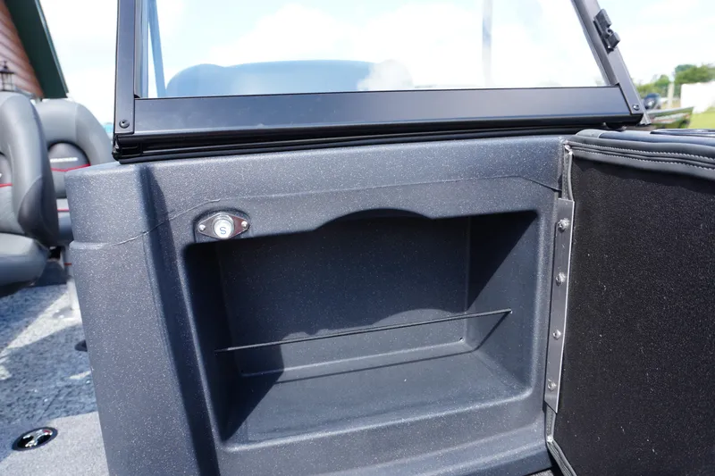 Slide: The Image of 2026 Tracker Targa V-18 WT boat interior storage compartment with seating in background. - 9